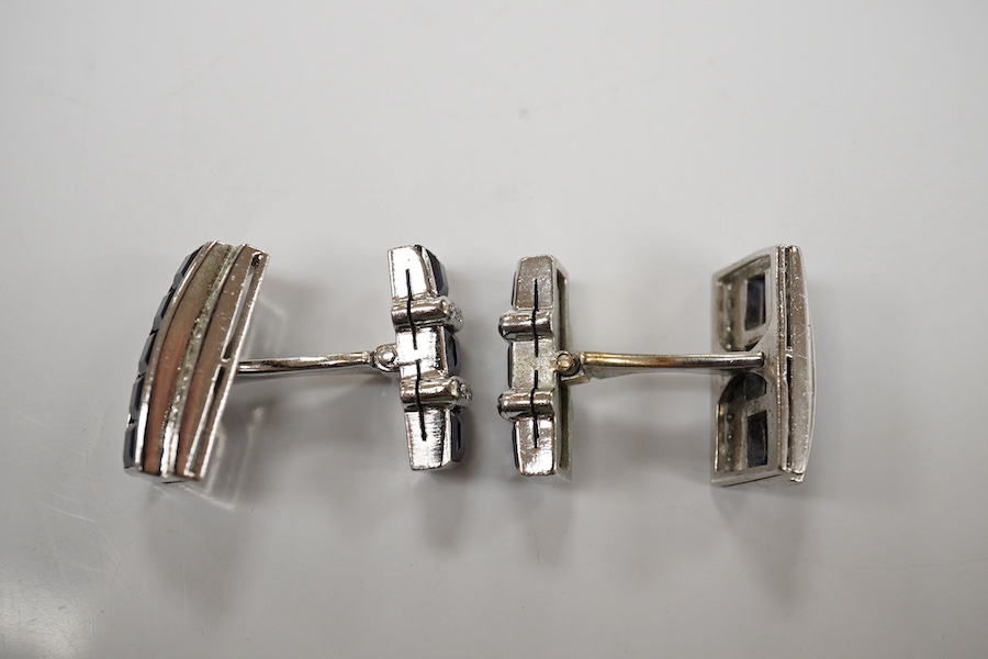 A pair of white metal, synthetic sapphire and diamond three row line cuff links, of curved rectangular form, 18mm, gross weight 16.6 grams. Condition - fair to good